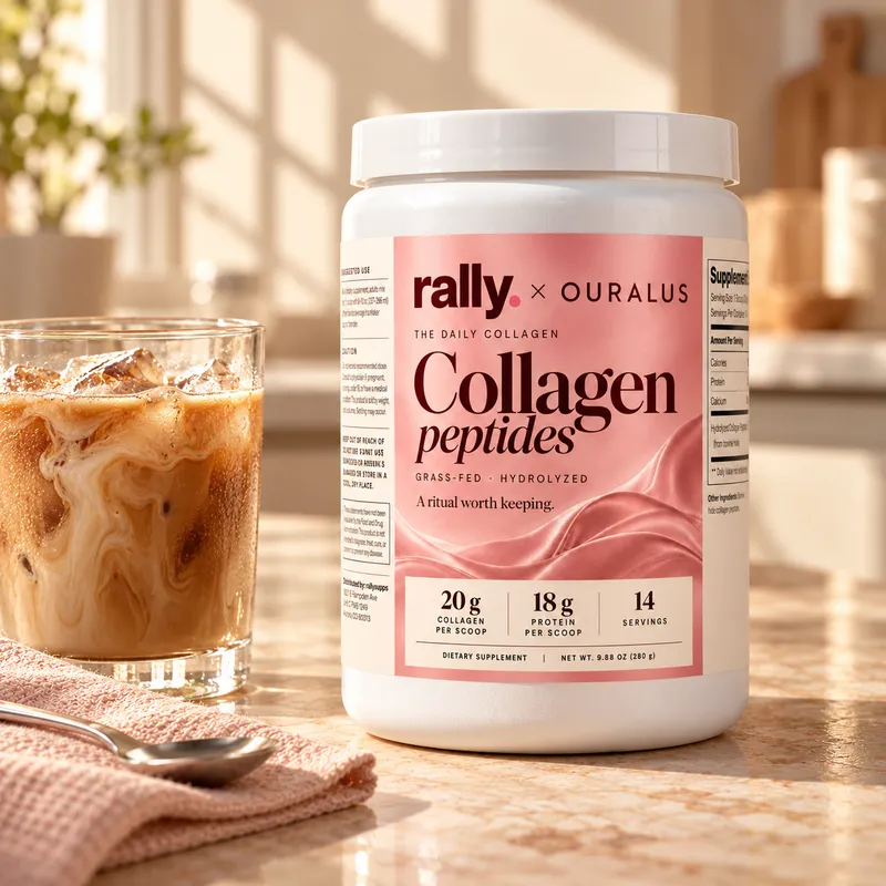 The Daily Collagen tub on a kitchen counter next to an iced coffee