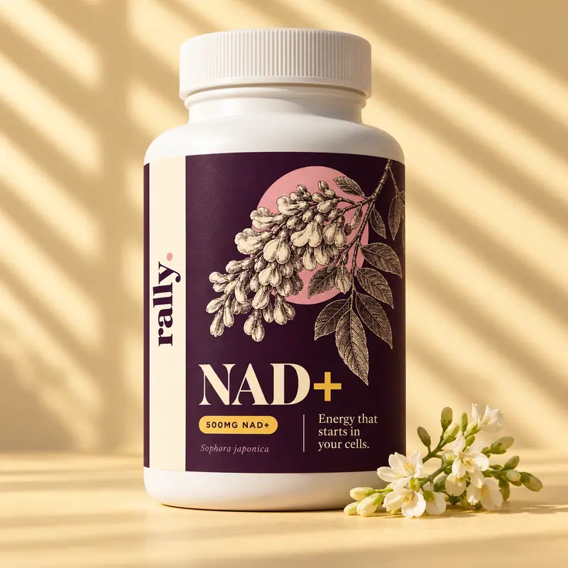 Rally NAD+ bottle in warm sunlight with a sprig of white flowers