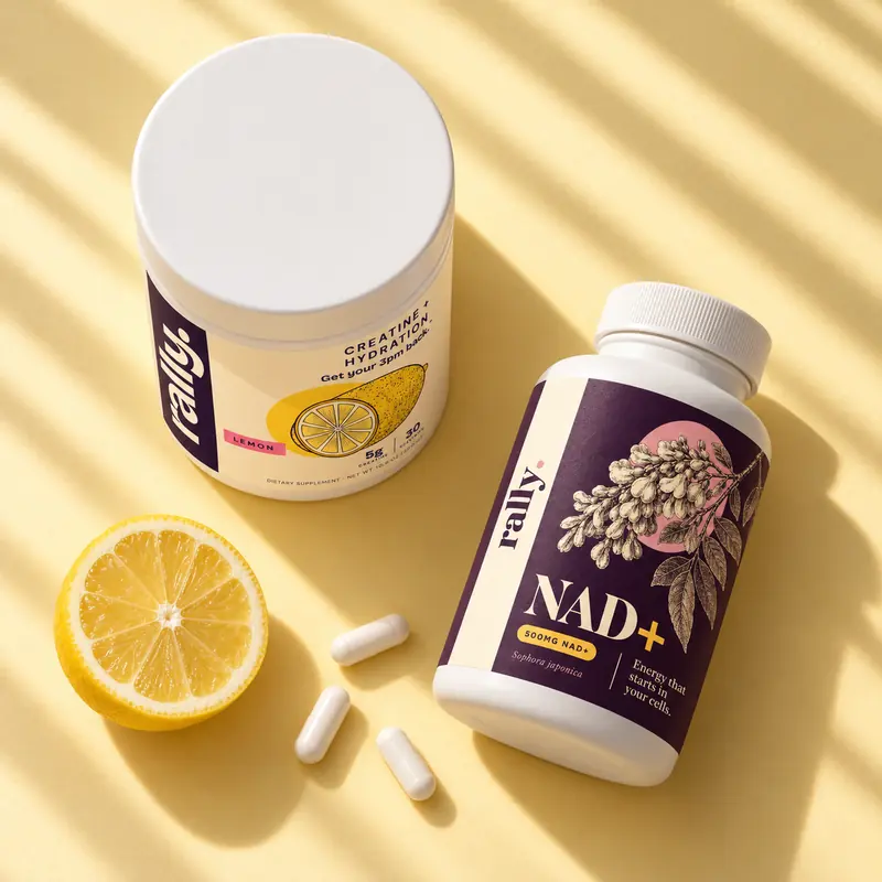 Rally tub and NAD+ bottle from above with a halved lemon and capsules on butter yellow